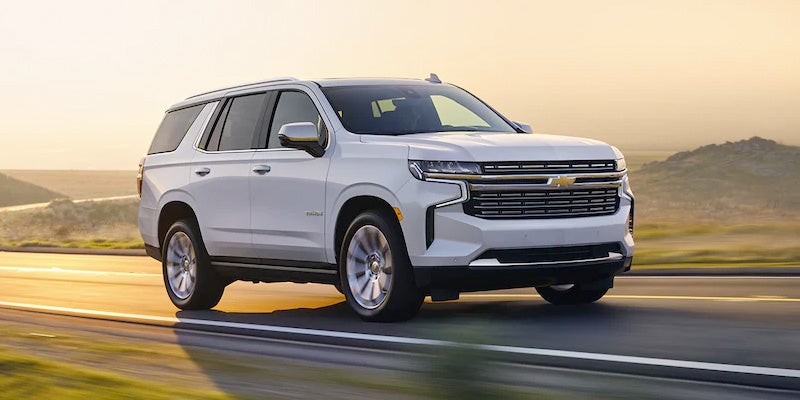 2022 White Chevy tahoe driving on road