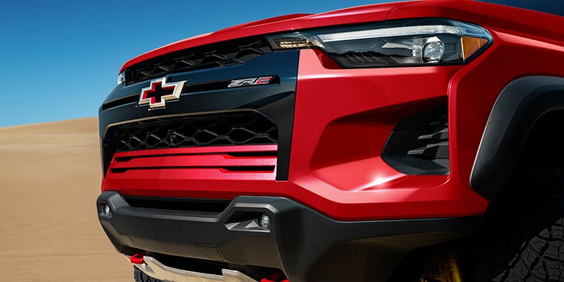 Red Chevrolet Colorado front bumper with Chevrolet logoleftfront view