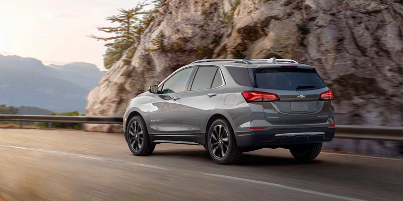 Gray SUV driving on mountain road