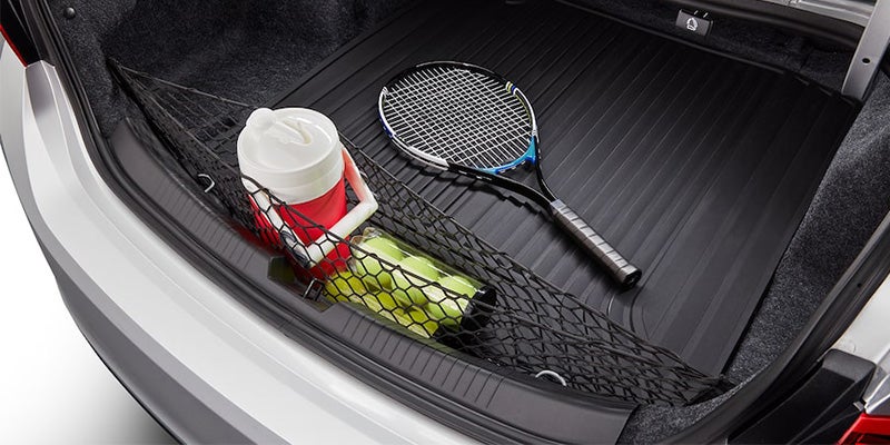 badminton racket, water jar and balls are placed inside the Chevrolet Malibu's trunk