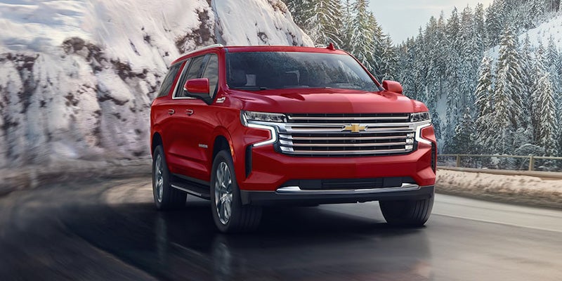 Chevrolet Suburban driving with icy mountain backdrop