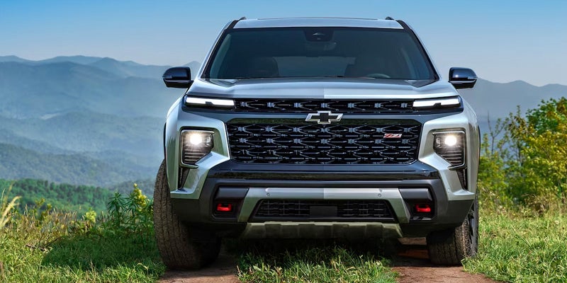 Chevrolet Traverse parked on hill in jungle