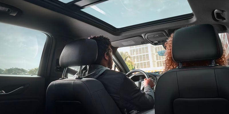 A couple is enjoying driving of Chevrolet Blazer with luxurious interior.