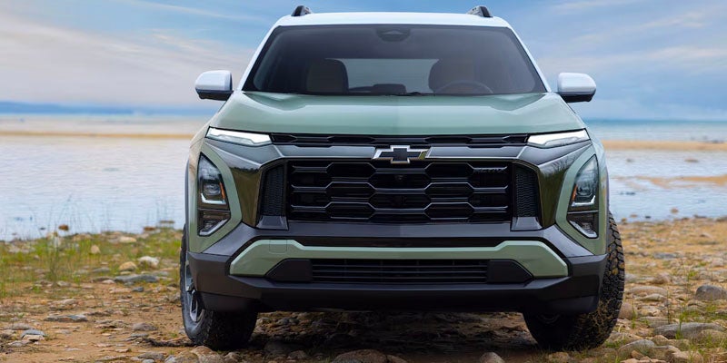 Green equinox standing on beach by turning tires to left side front view