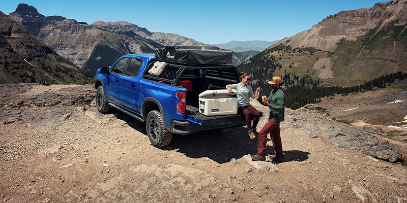 A couple is enjoying picnic with Chevrolet Silverado
